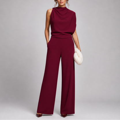 Model wearing the jumpsuit in burgundy with a draped cowl-style neckline and matching heels 7