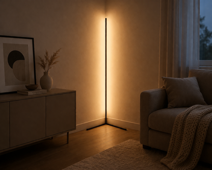 Warm white lamp glowing softly in a room corner next to a sideboard, framed print and knitted throw. 5