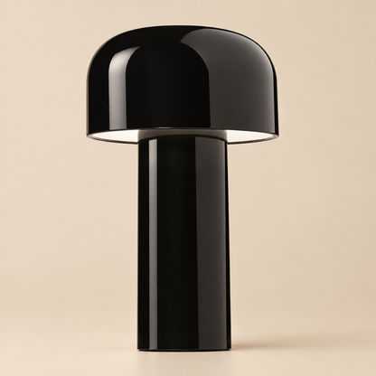 Close view of the glossy black lamp, its domed shade and cylindrical stem against beige 33