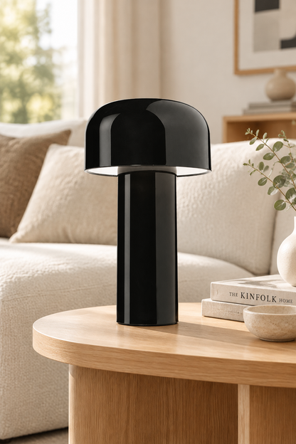 Glossy black mushroom lamp on a wooden side table next to a cream sofa 30