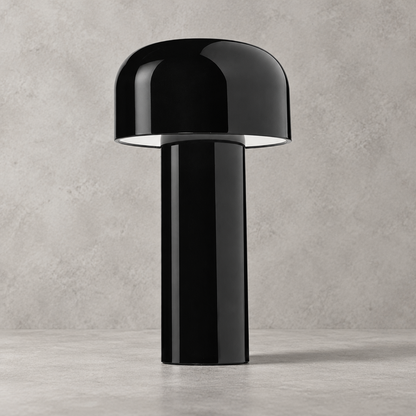Glossy black lamp with domed shade, close view against a concrete-effect wall 33