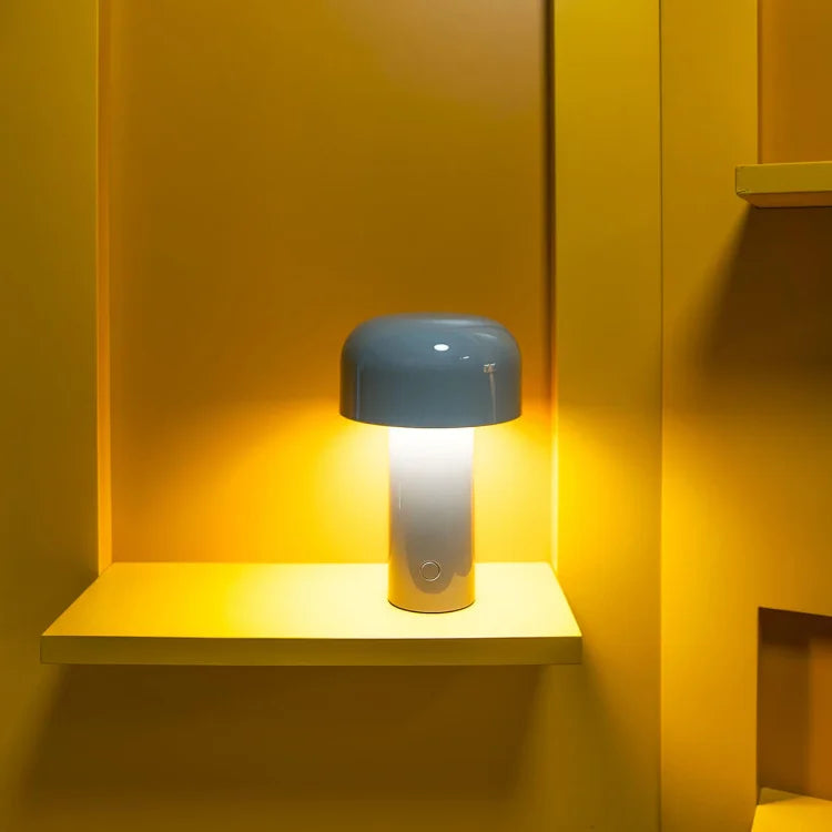 Blue-domed lamp with a bright white glow on a yellow shelf in a yellow alcove 12