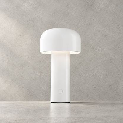 White glossy lamp lit against a concrete-effect wall, showing the round touch button on the base 28