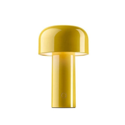 Glossy yellow mushroom lamp with a domed shade and round button on the base, on white 5