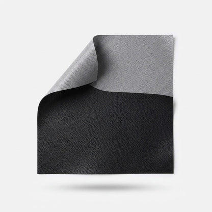 Square black patch with one corner turned back to show its grey adhesive underside 16