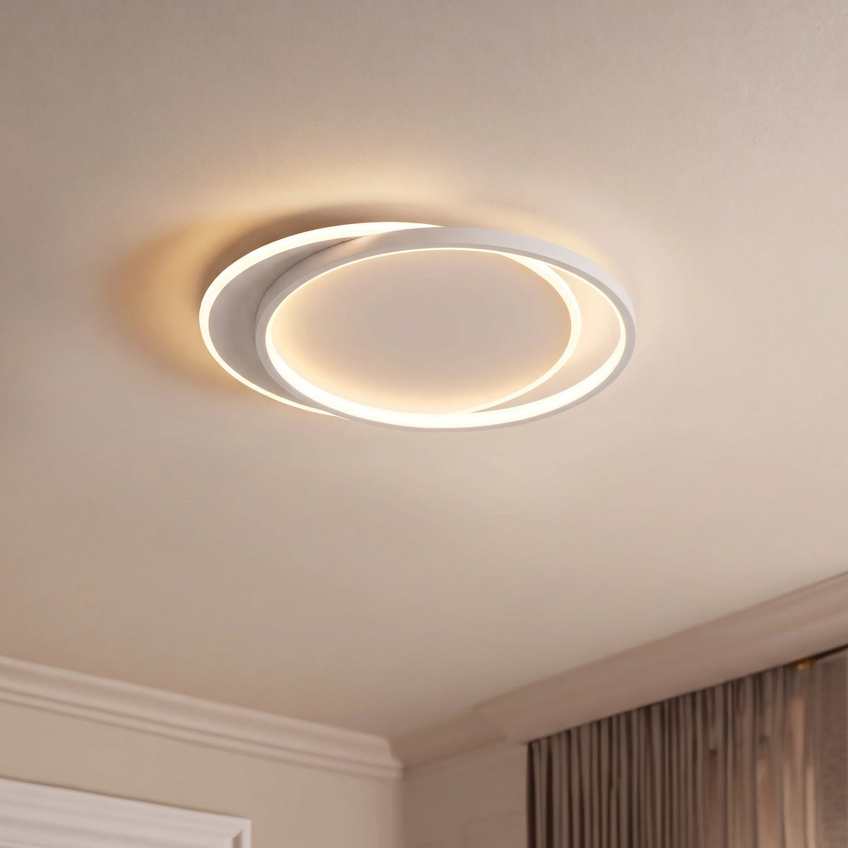 Lit ceiling light seen at an angle in a bedroom corner with cornicing and curtains 3