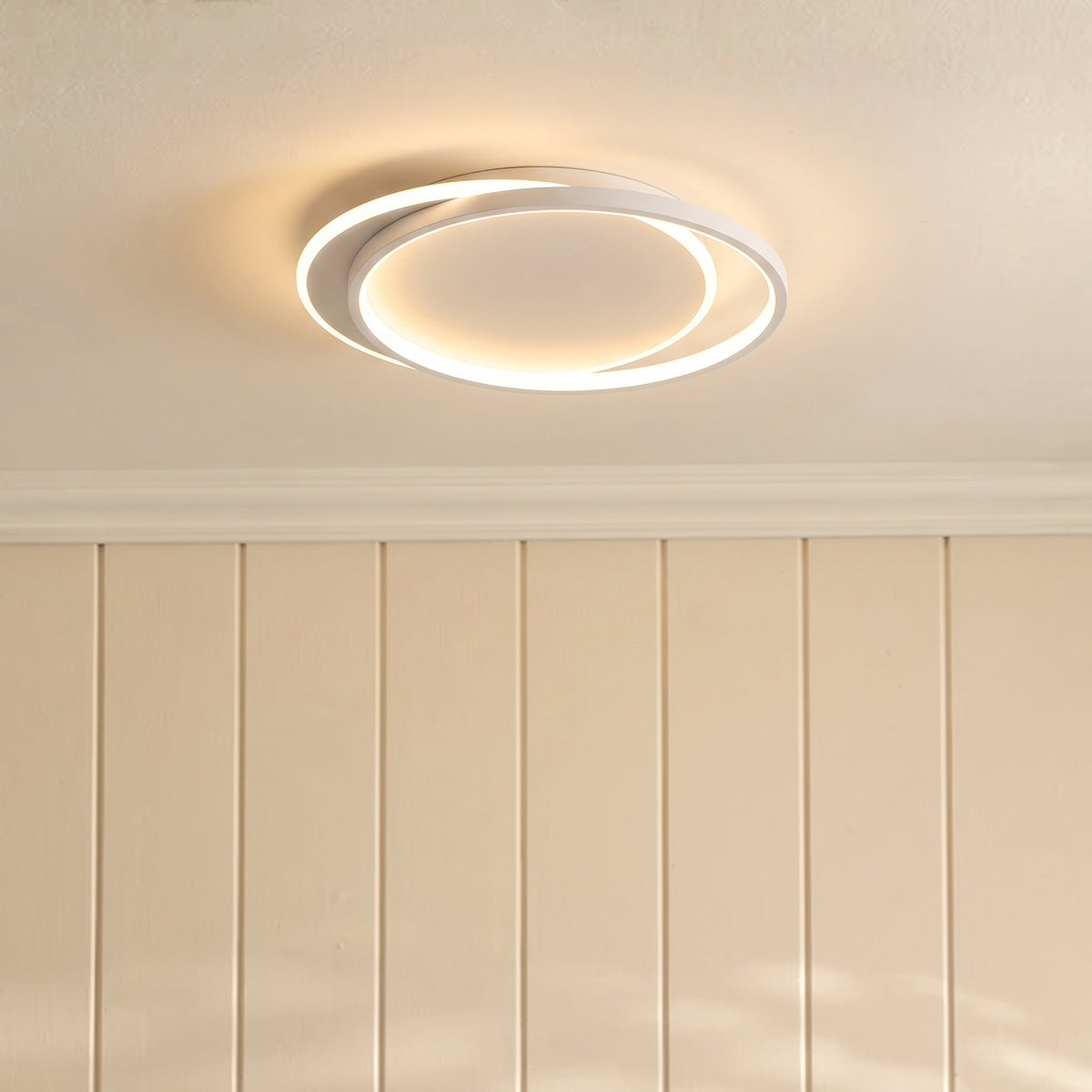 Side view of the lit ceiling light above cornicing and cream wall panelling 8