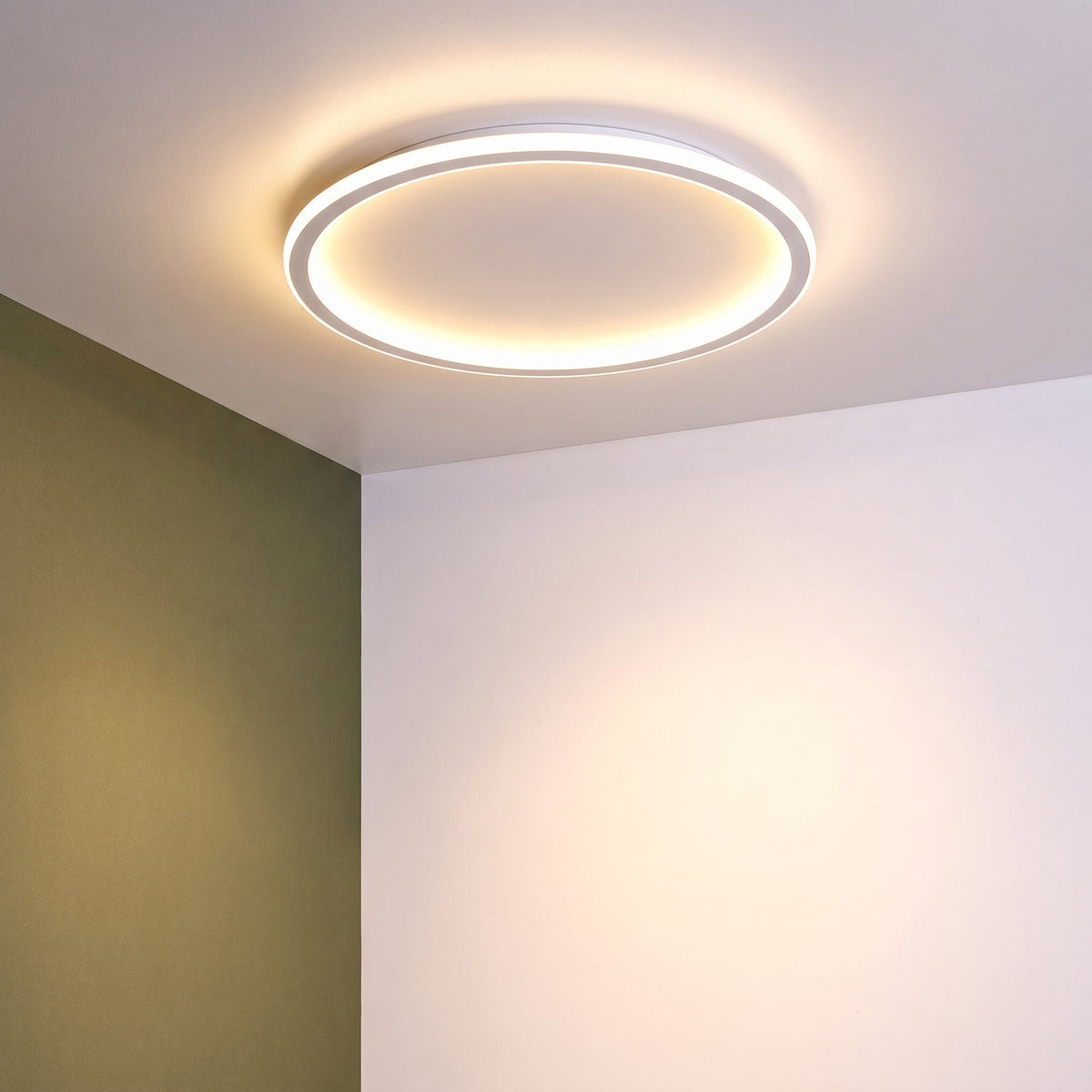 Ceiling light switched on in the corner of a room with one olive green wall and one white wall. 10
