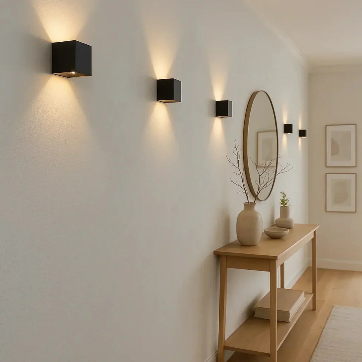 Row of black cube lights glowing up and down along a hallway wall beside a console table 3