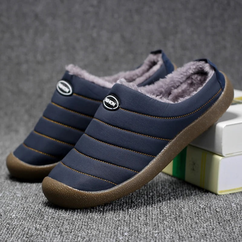 Navy quilted slippers with plush grey lining, one propped against a stack of books 5