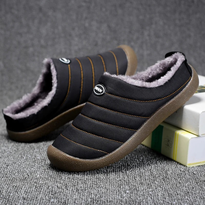 Black fleece-lined slippers with orange stitching, one tilted to show the inside of the other 8