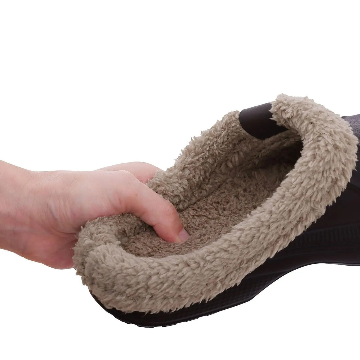 Hand pressing into the soft, thick faux fur lining inside a dark clog 8
