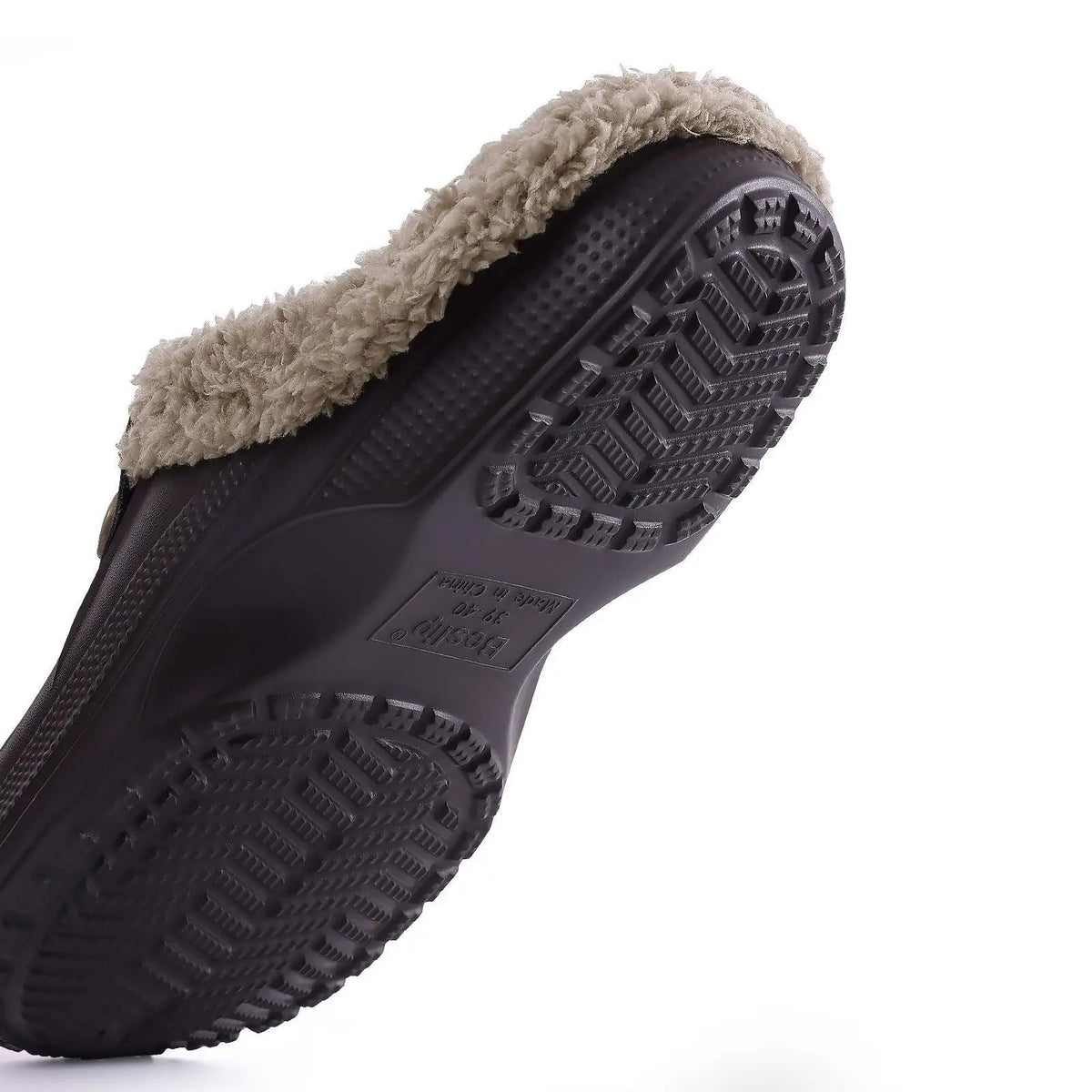 Underside of a dark brown clog showing the chevron-patterned grip sole and fur trim 9