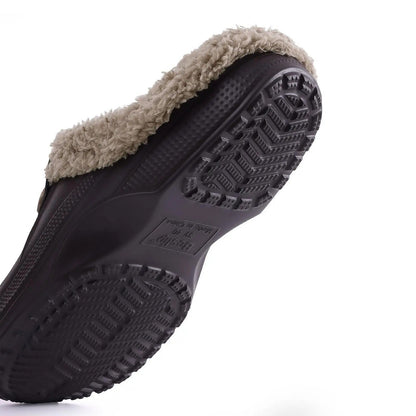 Underside of a dark brown clog showing the chevron-patterned grip sole and fur trim 9