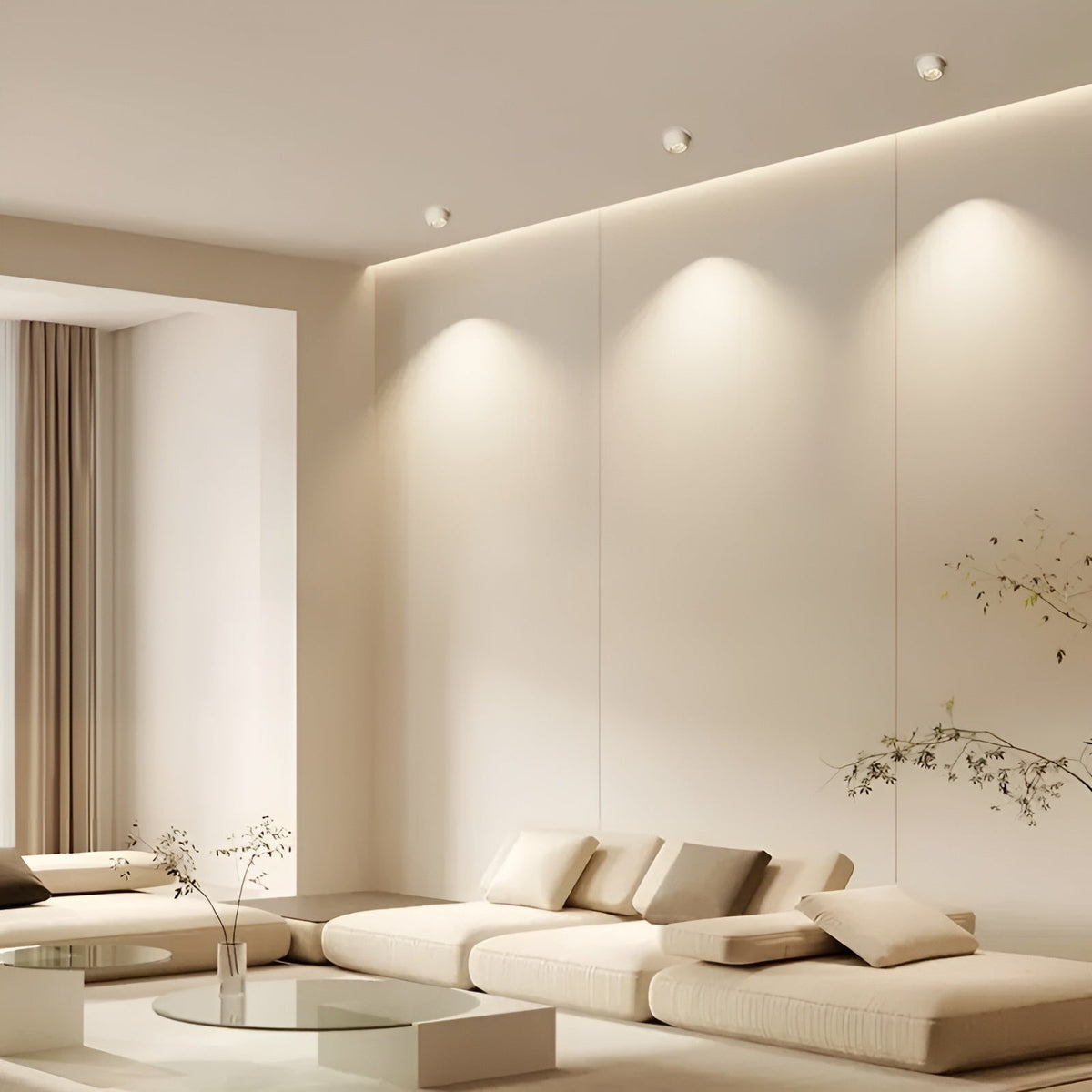 Three white recessed spotlights in a cream living room casting soft pools of light on the wall 2