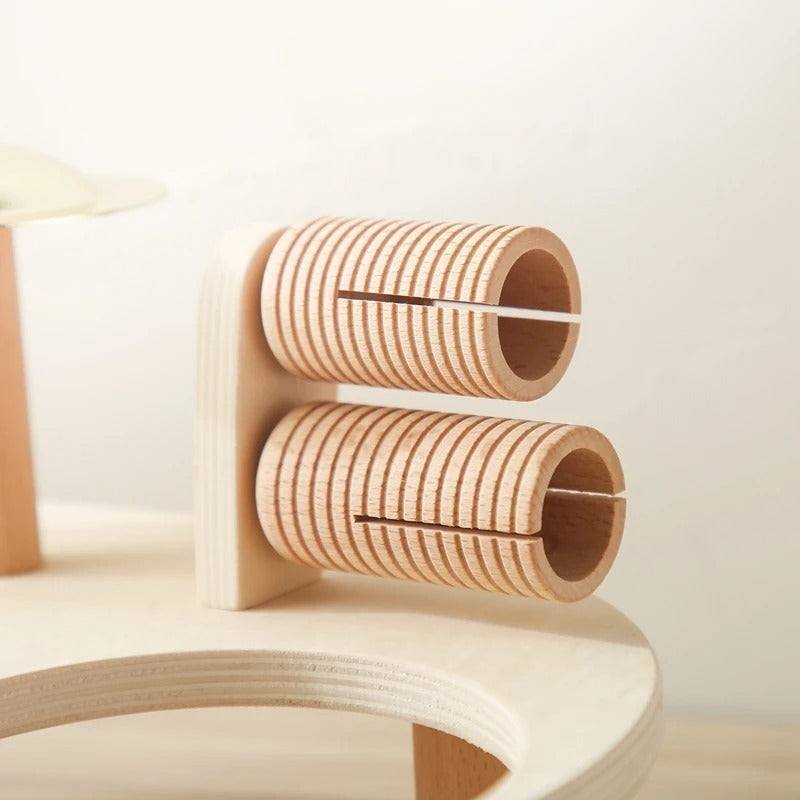 Close-up of the two slotted wooden guiro tubes mounted on an upright wooden panel 9
