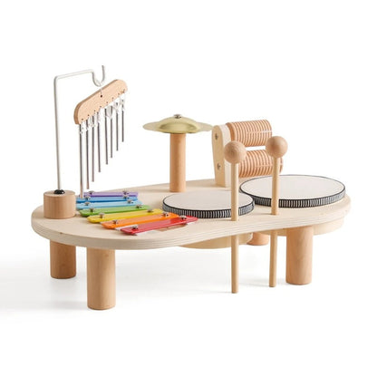Wooden music table with rainbow xylophone, hanging chimes, cymbal, two drums and guiro on a plain white background 1