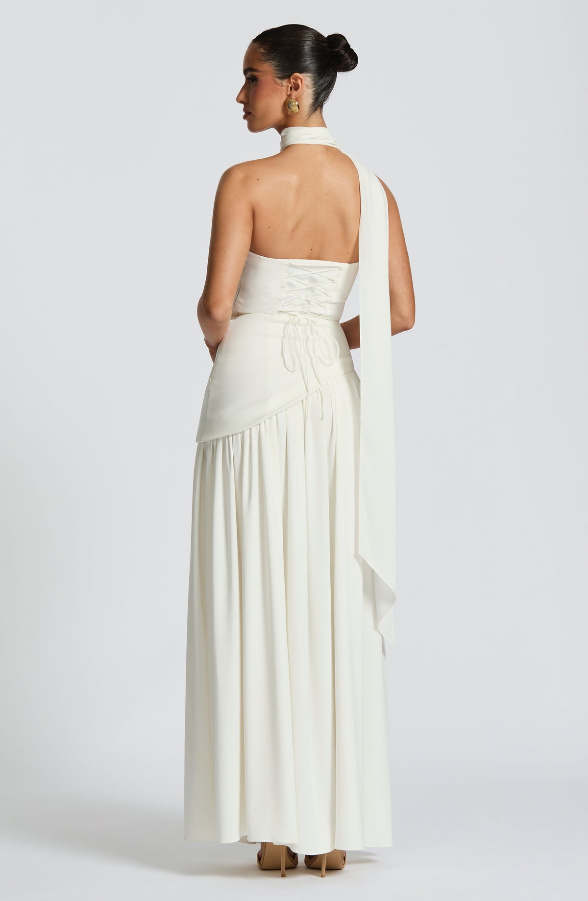 Back view of cream maxi dress with lace-up corset back and scarf falling over shoulder 37