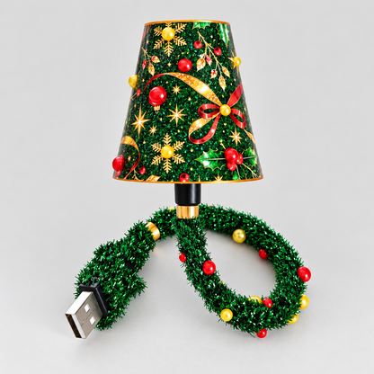 Small festive lamp on a plain light background, with a holly and bauble patterned shade and a green tinsel-covered USB cable. 1