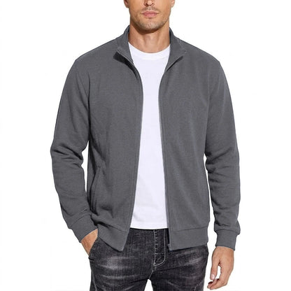 Man wearing the dark grey zip-up jacket open over a white t-shirt with dark jeans, front view. 5