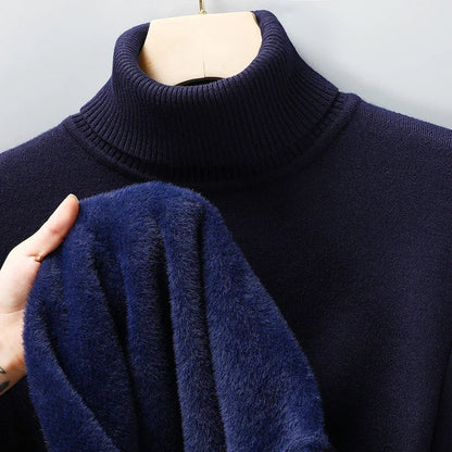 Navy turtleneck jumper on a hanger, with a hand showing the plush blue lining inside 7