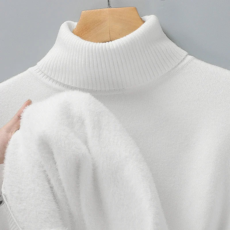 White turtleneck jumper on a hanger, with a hand showing the soft fluffy lining inside 5