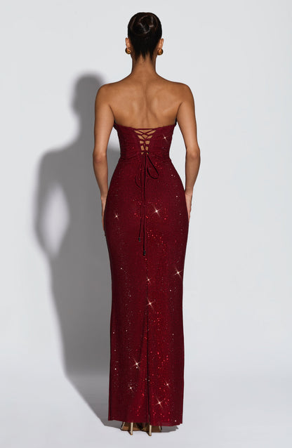 Back view of the burgundy sparkling maxi dress showing the criss-cross lace-up corset back with trailing ties. 2