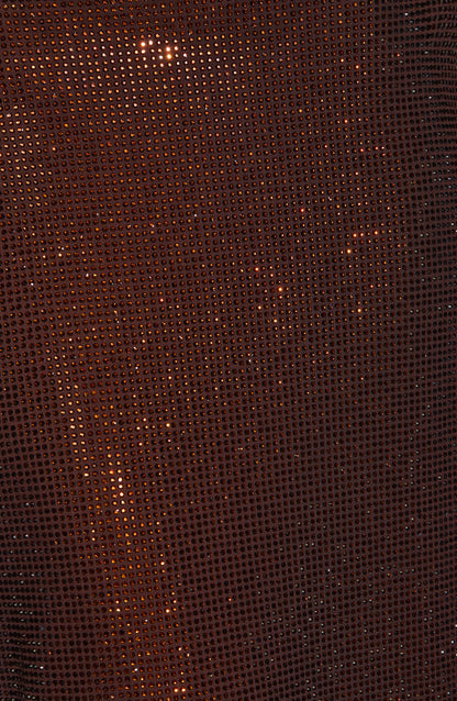 Extreme close-up of the brown fabric's grid of small rhinestones sparkling over the mesh. 9