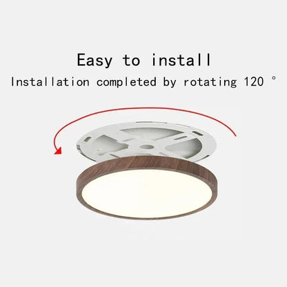 Dark wood-effect ceiling light beside its white mounting bracket, with a red arrow showing the twist-on installation. 1