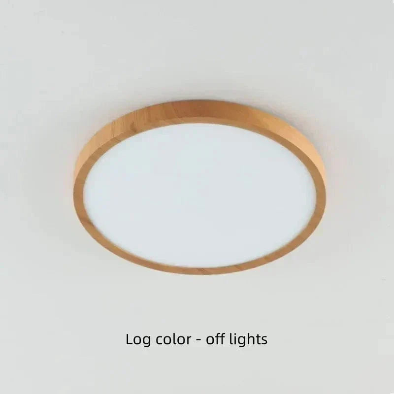Light natural wood-finish round light on a ceiling, switched off, showing its pale frosted diffuser. 19