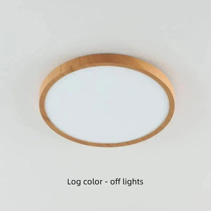 Light natural wood-finish round light on a ceiling, switched off, showing its pale frosted diffuser. 19