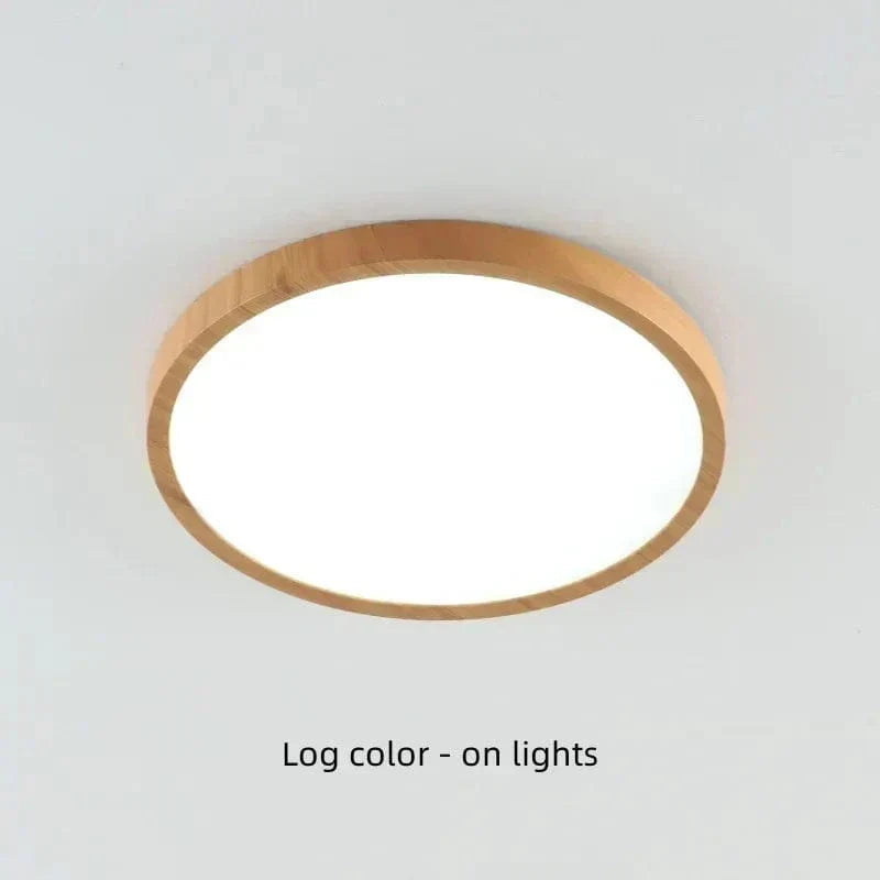 Light natural wood-finish round light on a ceiling, switched on and shining brightly through its diffuser. 20