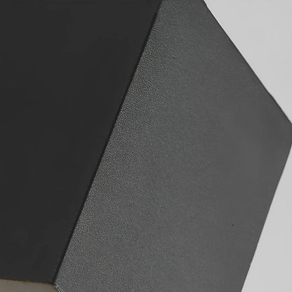 Close-up of the black lamp body's matte, finely textured finish and sharp square edges 14