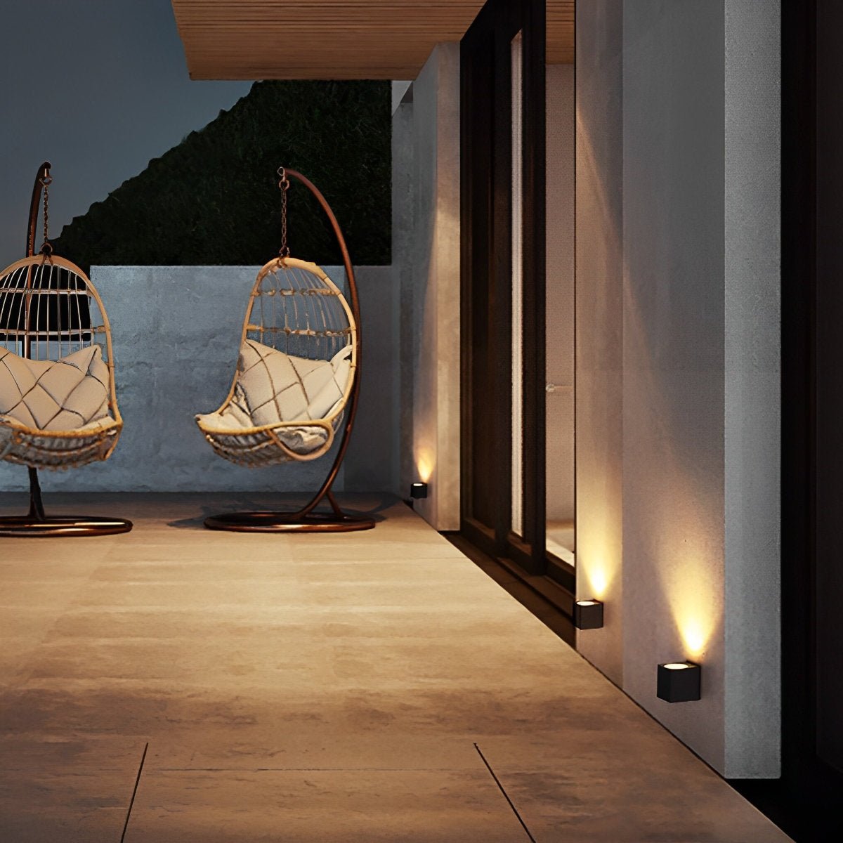 Small black wall lights low along a terrace wall, with hanging rattan egg chairs nearby 10