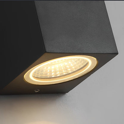 Close-up of the lit lens and textured reflector on the underside of the black lamp 13