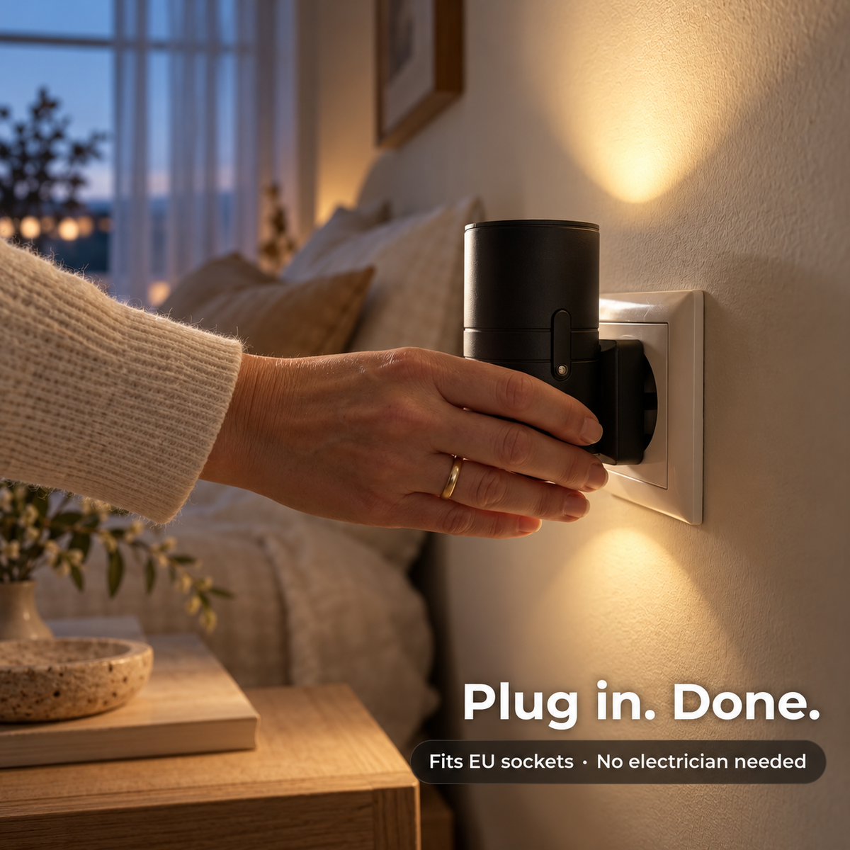 Hand pushing the black light into a wall socket beside a softly lit bedside 4