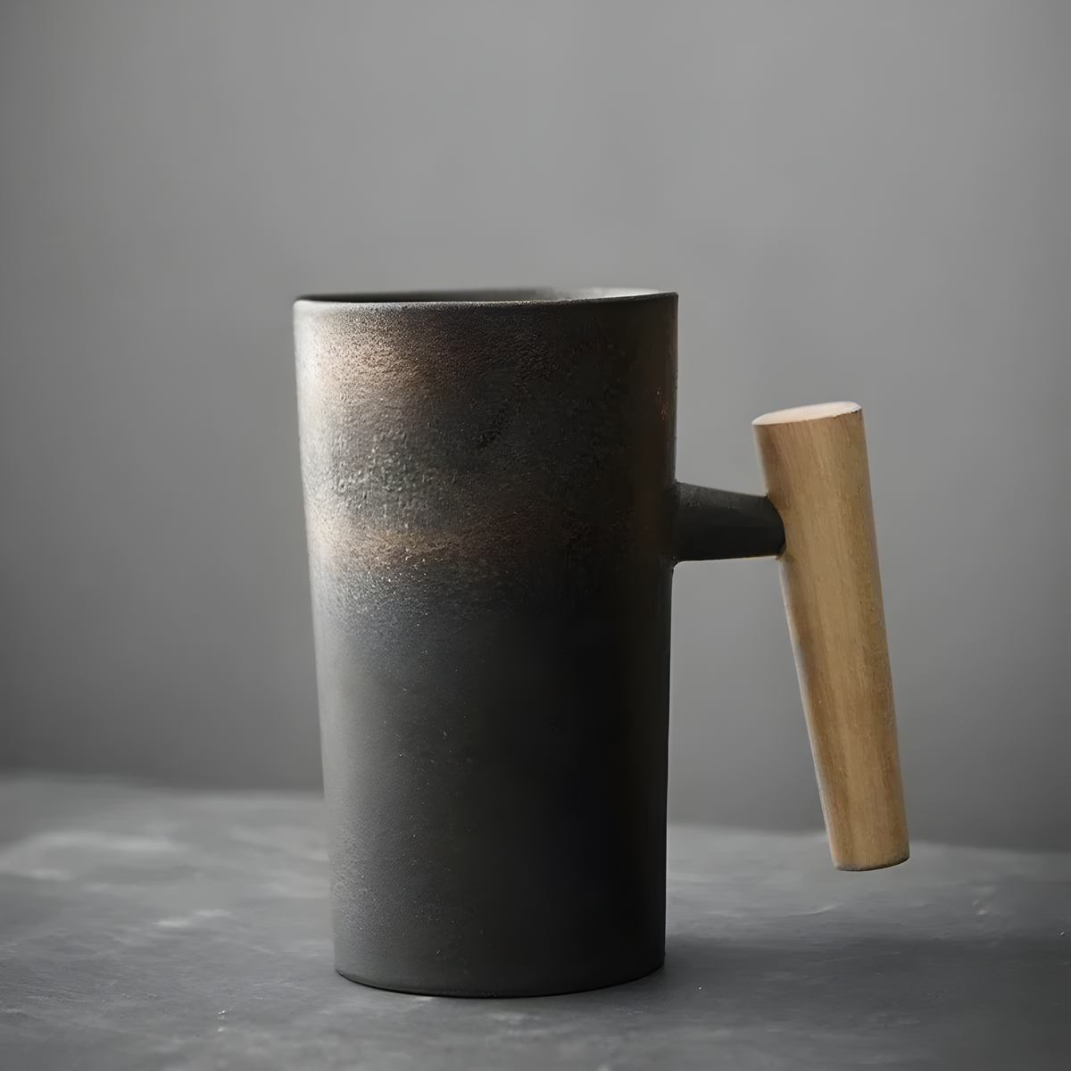 Charcoal stoneware mug with a rust-brown gradient near the rim and a light wooden handle 4