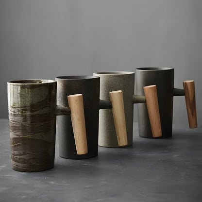 Row of four tall stoneware mugs in different glazes, each with a wooden handle, seen from the handle side 5