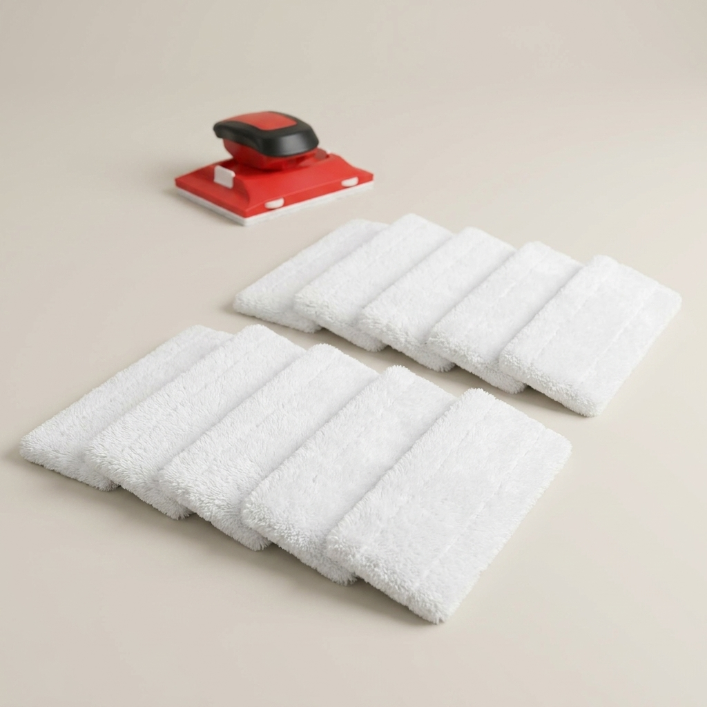 Ten white fluffy replacement pads laid out in two rows, with a red and black paint edger in the background. 2