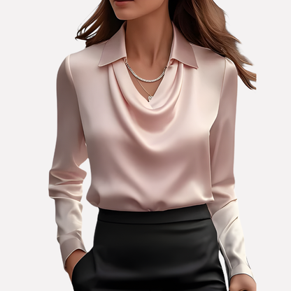 Model wearing the blush pink satin blouse with a draped cowl neckline, layered necklaces and a black skirt 9
