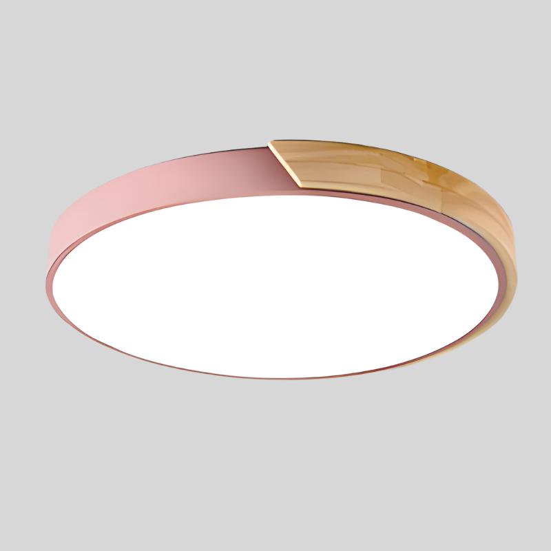 Pink round ceiling light with a wooden segment on the rim, shown from below against a plain grey background. 16
