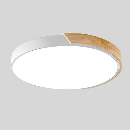 White round ceiling light with a wooden segment on the rim, shown from below against a plain grey background. 18