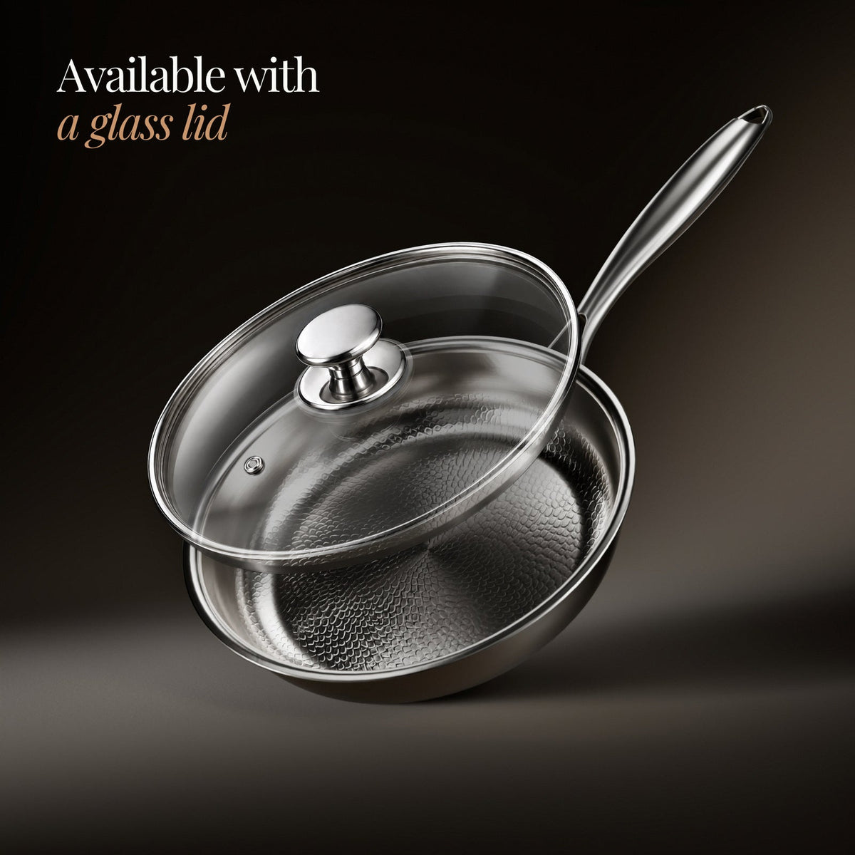 Frying pan with a clear glass lid and steel knob resting on top, shown at an angle with the hammered interior visible. 3