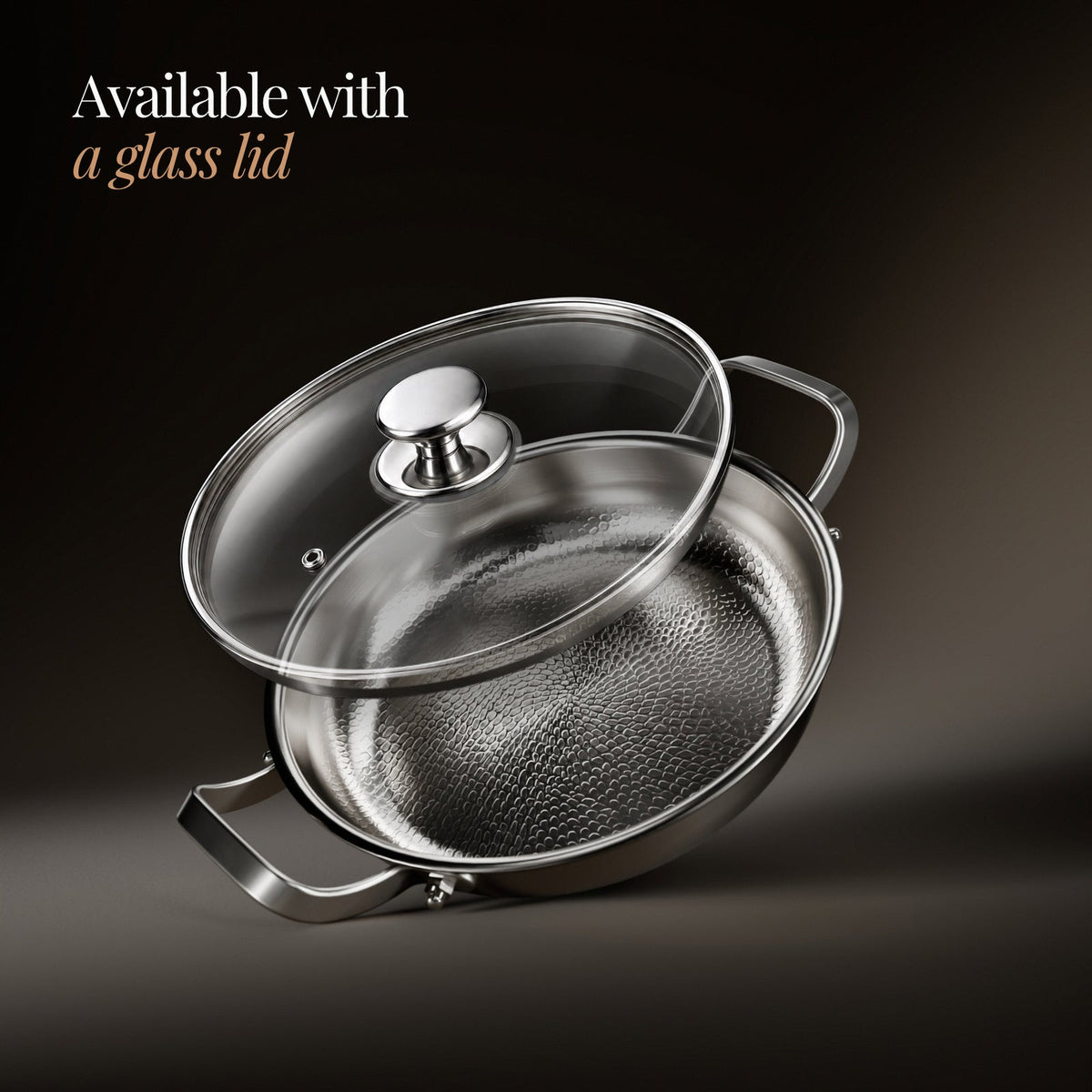 Pan tilted at an angle with a clear glass lid lifted above it, showing the metal knob and the hammered interior. 3