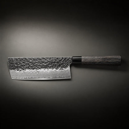 Side view of the knife laid horizontally on a dark background, showing the full hammered blade, rippled steel pattern near the edge and wooden handle. 2