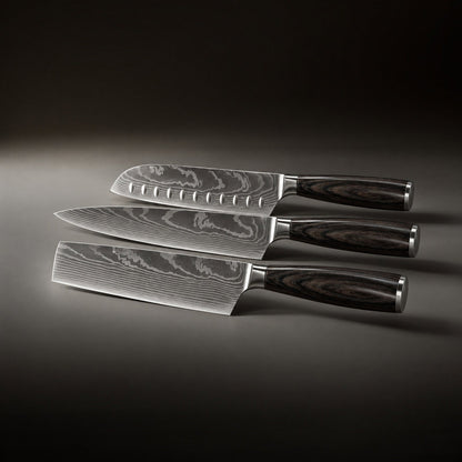 The three knives laid flat side by side, showing the grooved blade, the pointed blade and the rectangular cleaver-style blade. 2