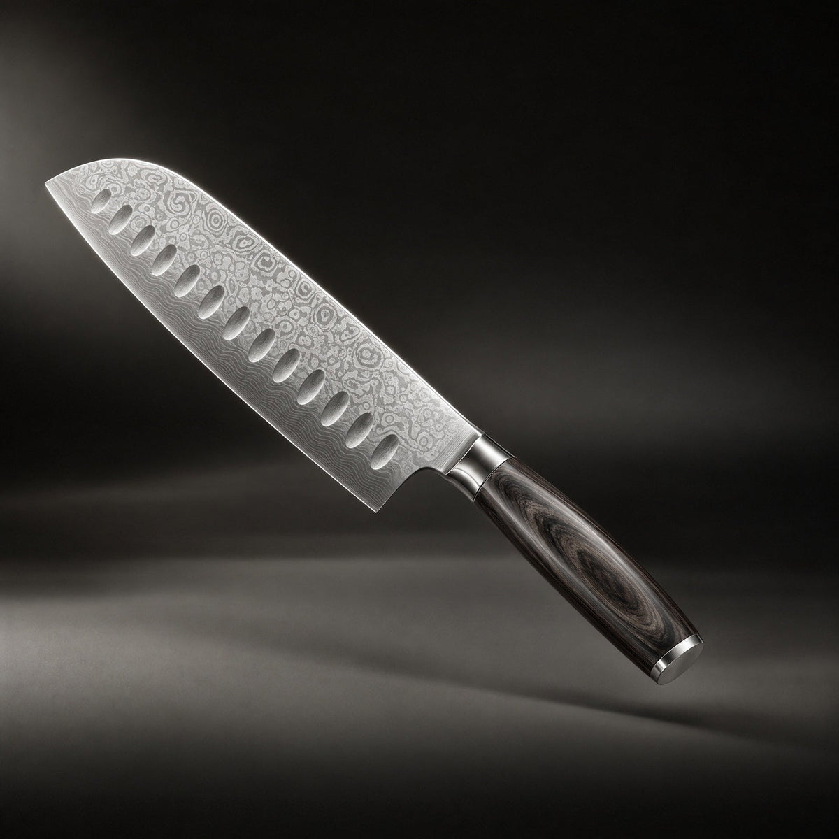 Santoku knife angled against a dark backdrop, showing the rippled layered-steel pattern, hollow indentations and dark wooden 1