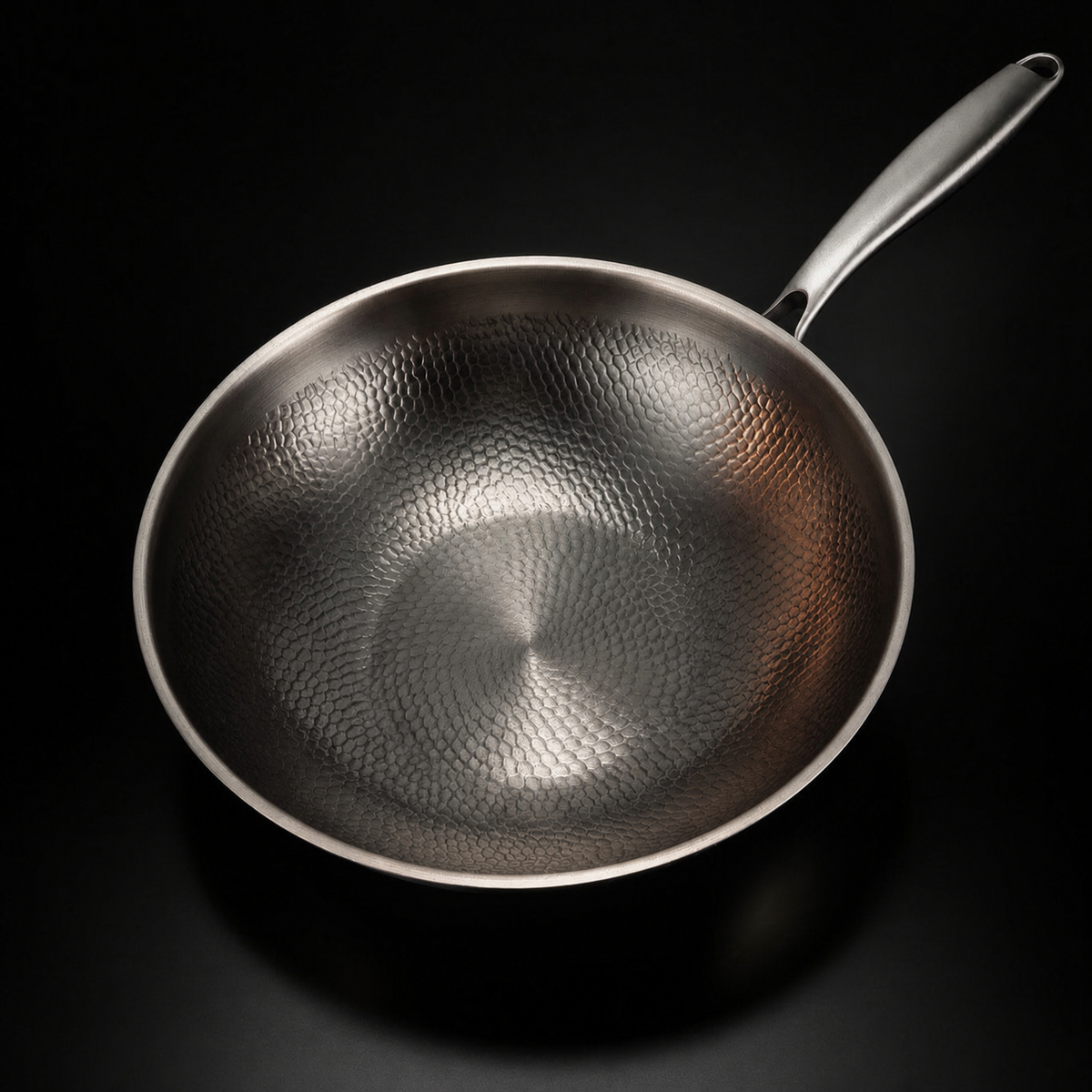 Overhead view of the empty wok, showing the hammered pattern across the inside of the bowl and the slim handle. 2