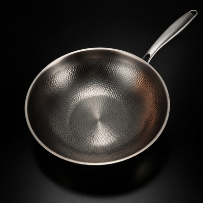 Overhead view of the empty wok, showing the hammered pattern across the inside of the bowl and the slim handle. 2