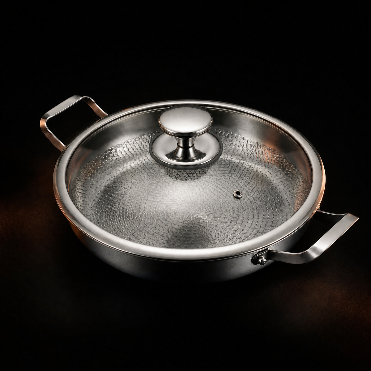 Pan with the glass lid in place on a dark background, showing the steel knob, steam vent and both side handles. 4